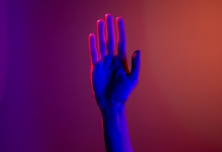 persons left hand with purple manicure